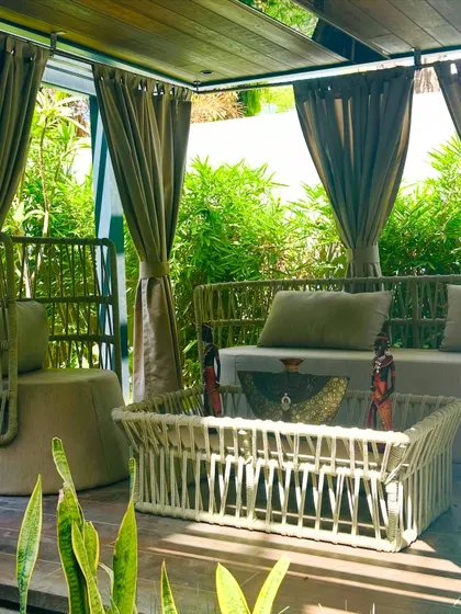The afternoon sun filters through the bamboo, highlighting the textures of the furniture. This space is designed to be beautiful and functional in any light.