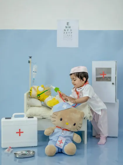 The little doctor in action, giving her patient an injection.