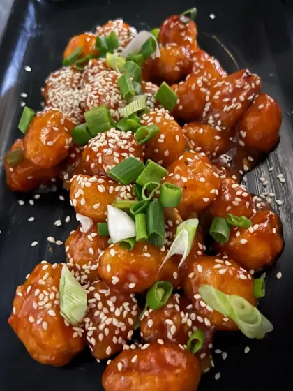 Our chef's special Waterchestnut Honey Chili. This dish is a perfect balance of crunchy water chestnuts tossed in a sweet and tangy honey chili sauce, garnished with sesame seeds and spring onions.