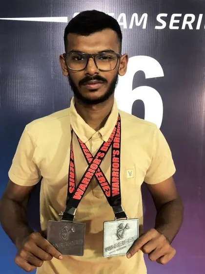 One of our fighters displaying his two silver medals from the Warrior's Dream Series. Consistent competition builds resilient athletes.