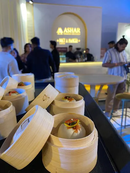 Shanghai Vegetable Bao Buns, served in individual bamboo steamers, ready to be enjoyed by guests at the Ashar Group event.