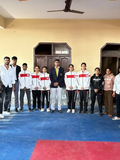 The senior competition team standing with their coaches, ready for any challenge.