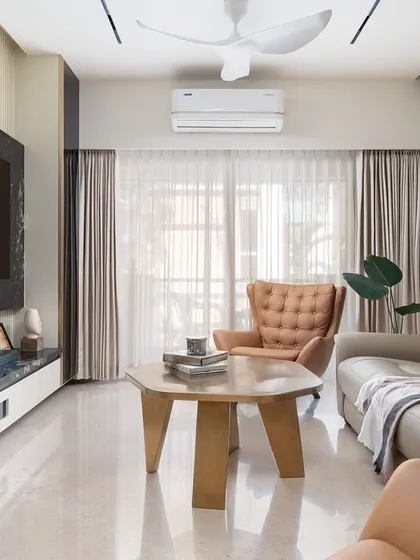 The living room of "Guilded Grace," a perfect blend of comfort and style with its plush recliner sofa and elegant decor.