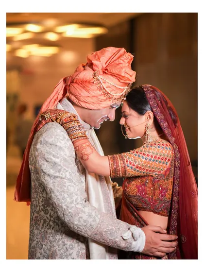 An intimate and joyful moment between the couple. The groom's happy expression and the bride's loving embrace create a beautiful, candid memory.