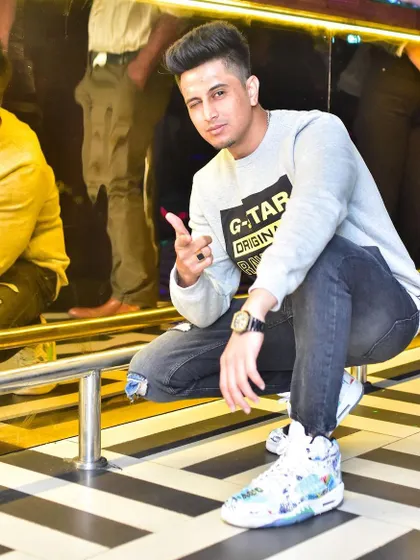 Crouching down for a quick photo during a set. The black and white striped floor is almost as iconic as the beats.