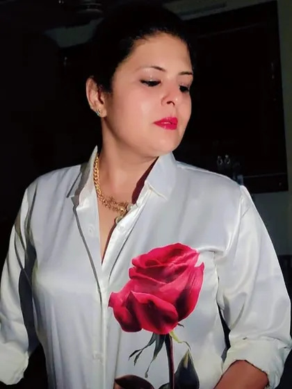 A white satin shirt with a hand-painted rose detail, paired with torn denims. This is how I elevate a simple shirt-and-jeans look for a party.