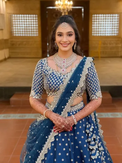 Minimal glam, maximum love. This bride's reception look is all about effortless charm, with soft makeup and a modern hairstyle that lets her natural beauty and happiness shine through.