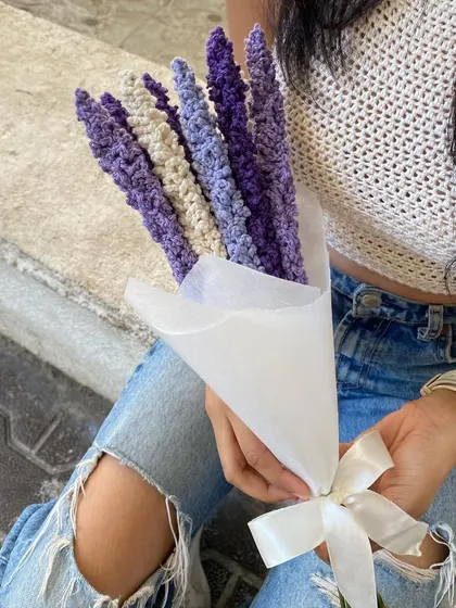 One of us holding a finished lavender bouquet. It's a great example of how our handmade flowers can add a touch of pinterest-inspired, sustainable style to your look or your home.