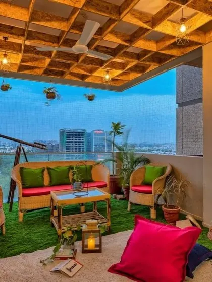 A duplicate view of a spacious balcony setup, highlighting the comfortable cane furniture. This angle shows how the seating arrangement creates a welcoming space for family and friends.