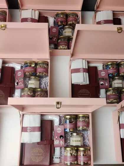 We designed these premium hampers for the store opening of Shaswat, a menswear brand. The elegant pink box contains a custom-branded diary, a white shirt, and an assortment of gourmet nuts and a scented candle.