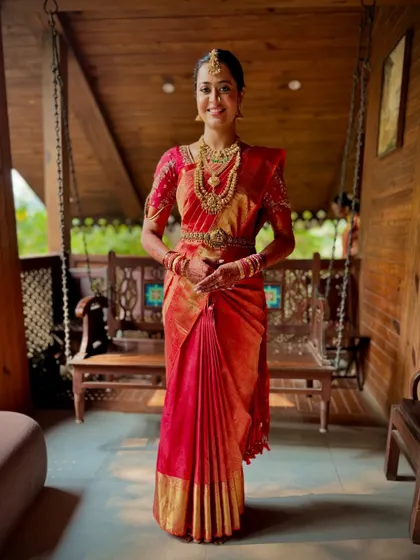 A beautiful real bride in a red Kanchivaram. The classic drape and her happy smile say it all.