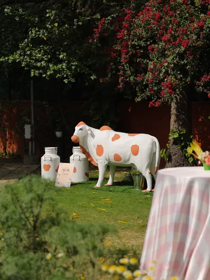 To make the farm theme truly immersive, we included life-sized props like this charming spotted cow and vintage milk cans. These details added an authentic touch to the whimsical barnyard atmosphere.