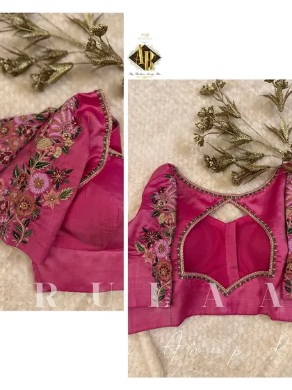 A beautiful pink blouse with multi-color floral embroidery on the sleeves. The back features a lovely keyhole cutout framed with the same detailed work.