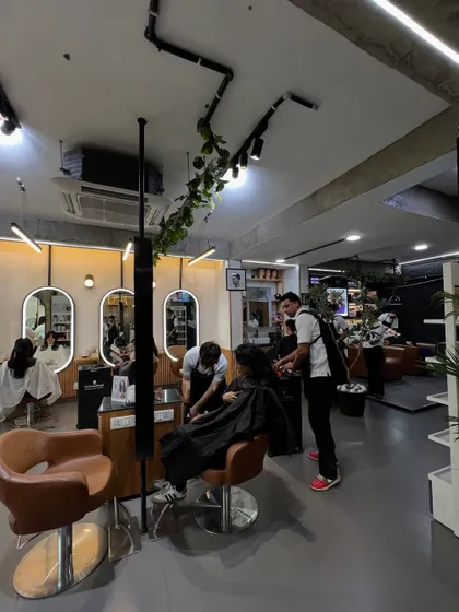 A wide shot of the salon floor, showing my team attending to several clients. The space is designed to be open and interactive, yet provide personal space for each service.