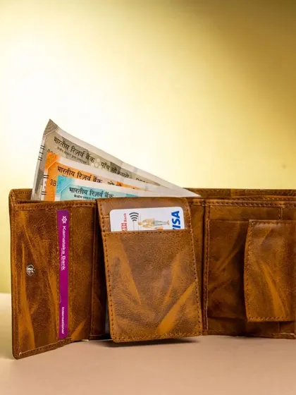 Here is an open view of the 3-fold wallet, showing its capacity for cash and cards. The rustic tan finish gives it a unique, vintage look.