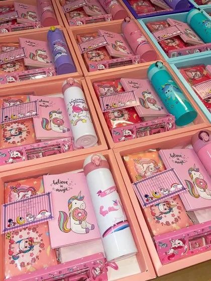 A look inside our unicorn-themed stationery hampers. These boxes are filled with a water bottle, notebook, pencil case, and other magical goodies.