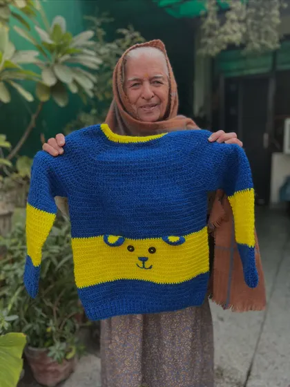 Simple, cute, and cozy. This blue and yellow striped sweater has a subtle bear face outline, making it a playful yet versatile piece for everyday wear.