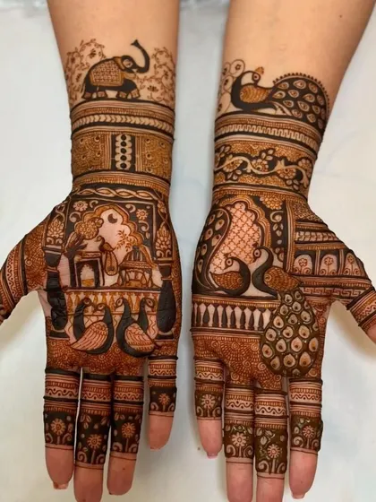 A beautiful design featuring a woman in a jharokha on one palm and peacocks on the other. The arms are adorned with elephant and peacock motifs.