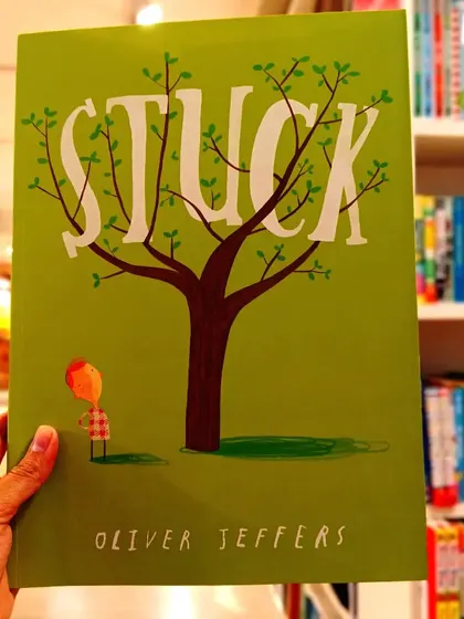'Stuck' by Oliver Jeffers is a hilarious and absurdly brilliant story about a boy who gets his kite stuck in a tree, and the increasingly silly things he throws up to get it down.