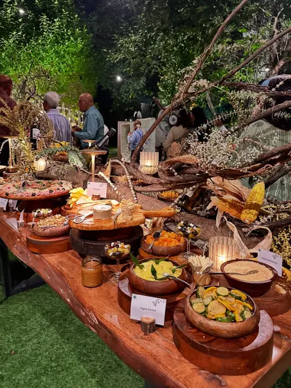 I believe food should be a sensory journey. This rustic grazing table, laden with artisanal cheeses, fresh produce, and gourmet bites, is an example of the bespoke culinary experiences I create.