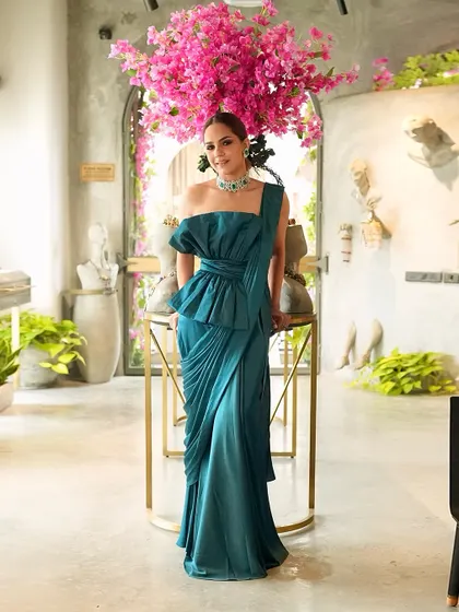 For a cocktail look, we styled this stunning emerald one-piece formal outfit from Ridhi Mehra, elevated with a statement emerald choker from Purab Paschim.
