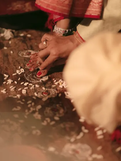 A close-up of a traditional wedding ritual involving the bride's feet, a detail rich with cultural significance.