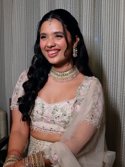 A playful and cute moment. Her makeup is fresh and youthful, perfect for her personality and the light, floral-embroidered lehenga.