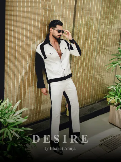 A full-body shot of the black and white color-blocked co-ord set. The sharp contrast and modern design create a visually striking and confident silhouette.