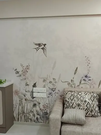 The same wildflower wallpaper shown in a living room context, demonstrating its versatility. I installed it above the sofa for a calming, natural touch.