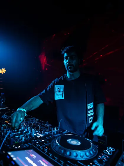A moment of concentration at the DJ booth. I'm constantly tweaking EQs and effects to shape the sound and keep the energy flowing on the dancefloor.