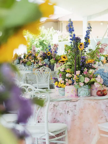 The guest tables were a riot of color, with floral-print tablecloths and large, wild arrangements of summer blooms.
