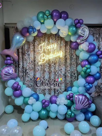Another take on the Mermaid theme, this balloon ring uses shades of purple and teal for a 9th birthday celebration.