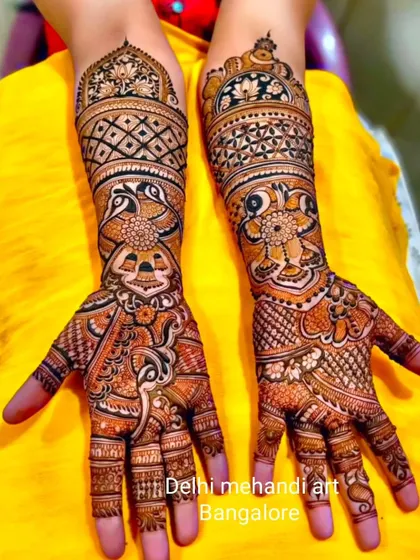 A vibrant and colorful design featuring a mix of peacocks, elephants, and floral motifs. The use of shading gives the design depth and dimension.