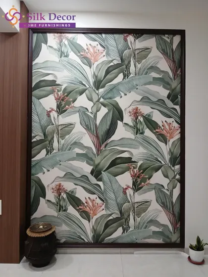This tropical leaf wallpaper is presented as a framed art panel, offering a sophisticated way to introduce a natural element into the decor. The rich green and blush tones of the foliage add a touch of elegance to the living area.