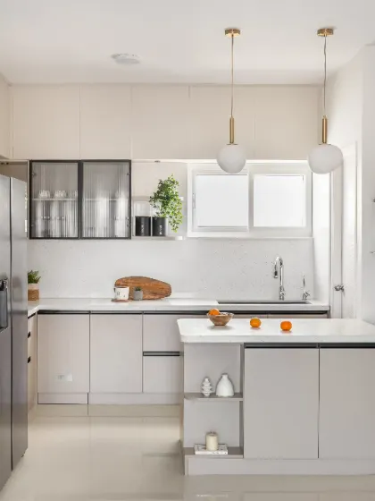This airy, light-filled kitchen is a chef's dream. I used a glass partition to separate the space without blocking light, and stunning pendant lighting over the island to make it a true masterpiece.