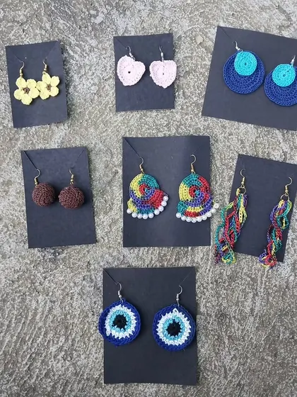 A glimpse into the variety of my handmade crochet earrings. From simple hearts and flowers to vibrant, multicolored designs, each pair is lightweight and adds a unique touch to any outfit.