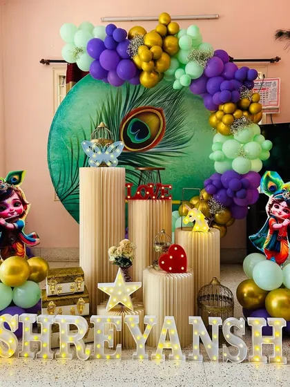 For a touch of tradition and fun, we offer a Little Krishna theme. This setup for Shreyansh includes a beautiful peacock feather backdrop, cutouts of baby Krishna, and a vibrant color scheme.