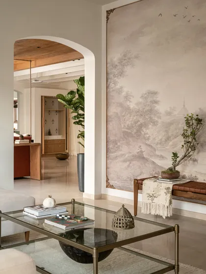 Arches and murals are two of our favorite design elements for adding character. In the Earthy Hacienda's formal living room, a soft arch leads the eye towards a custom framed mural, creating a calm, modern, and layered presence that draws you in.