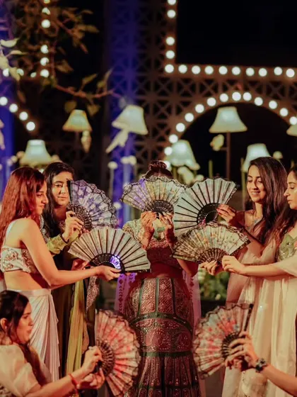 The bridesmaids' performance, using fans as props for a unique and stylish dance number.