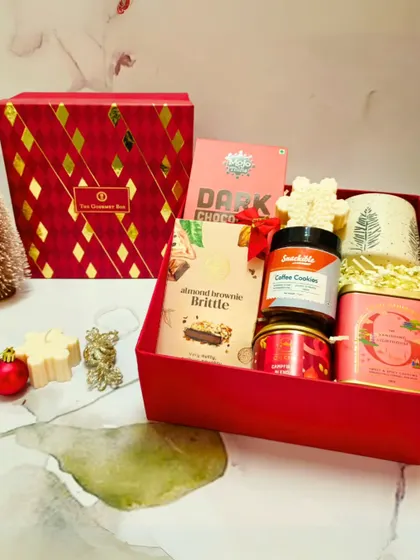 The Christmas Extravaganza Gift Box, featuring a festive mug, coffee cookies, and almond brownie brittle, all packed in a luxurious red box.