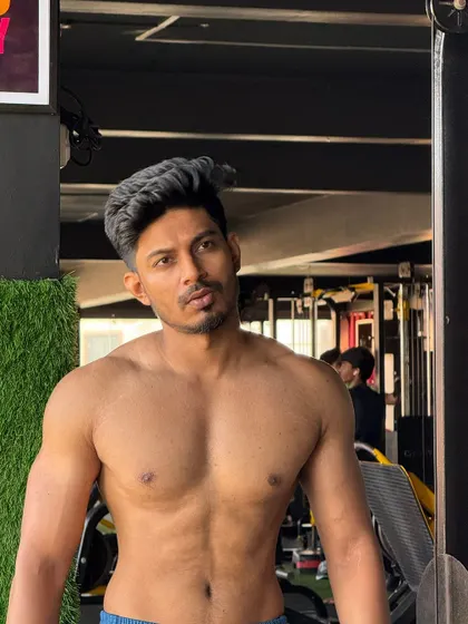 I don't chase, I attract. A shirtless portrait in the gym.