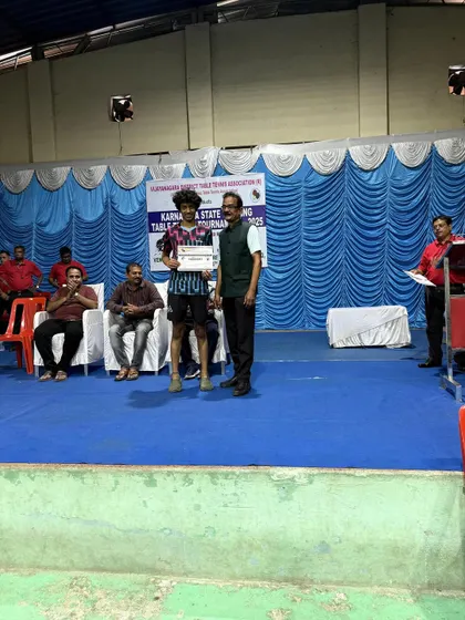 Abhinav K Murthy on the podium after securing 3rd place in the Men's Singles at the Hospet state ranking tournament.