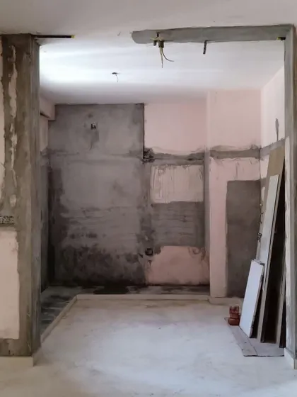 The kitchen and dining area after demolition. By removing the walls, I prepared the space for an open-concept layout with a breakfast counter, completely changing the flow and feel of the home.