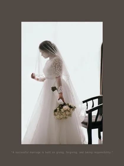 A pensive and beautiful portrait of the bride holding her bouquet, captured in a moment of quiet reflection.