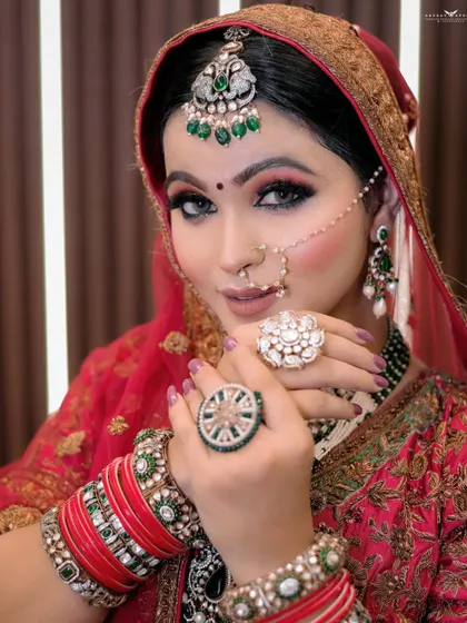 A portrait focusing on the bride's hands and jewellery. Her large, ornate rings are the centerpiece of this shot, showcasing the importance of bridal accessories.