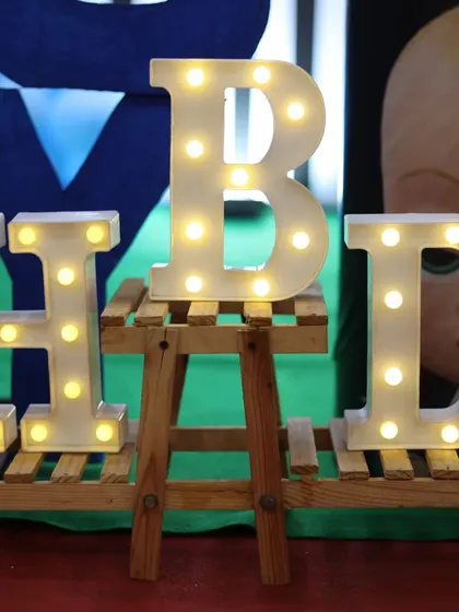 Details matter! These marquee letters spelling out 'BHD' were part of a larger Boss Baby themed decor, adding a bright and personalized touch to the setup.