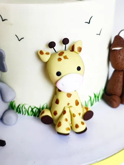 The sweet giraffe and dog toppers from the sunshine and animals cake. I can create any of your child's favorite animals to sit atop their birthday cake.