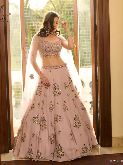 A beautiful shot of the pink floral crop top lehenga, perfect for a bride who loves a touch of modern romance.