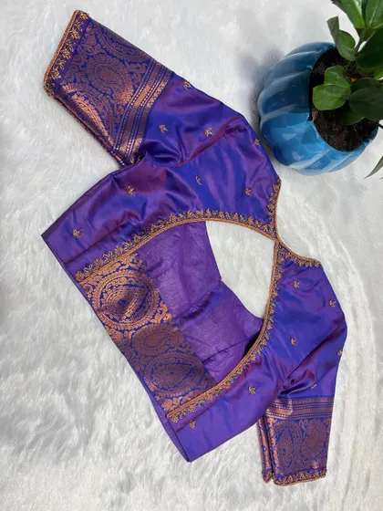 A royal purple blouse with copper and gold embroidery, giving it a unique, antique finish.
