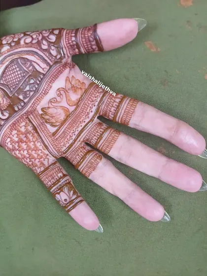 A close-up of the palm section of the design. This shot highlights the delicate swan and elephant motifs.